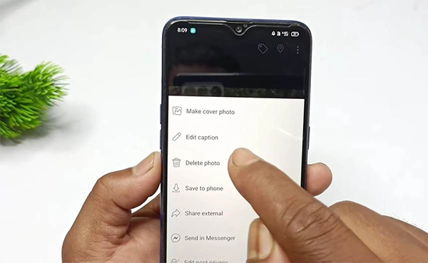 Screen showing Delete photo option from Facebook dropdown menu.
